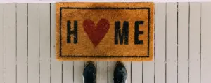 Doormat with Home written on it and a heart instead of the letter o in Home.
